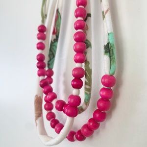The Jones Market pink and white floral fabric and wood teething necklace